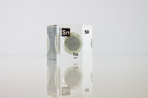 Clear acrylic cube displaying a Tin element (Atomic Number 50) embedded within, offering a scientific presentation for collectors and science enthusiasts.