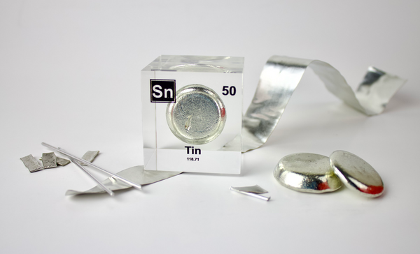 Clear acrylic cube displaying a Tin element (Atomic Number 50) embedded within, offering a scientific presentation for collectors and science enthusiasts.