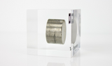 Clear acrylic cube displaying a Tungsten element (Atomic Number 74) embedded within, offering a scientific presentation for collectors and science enthusiasts.