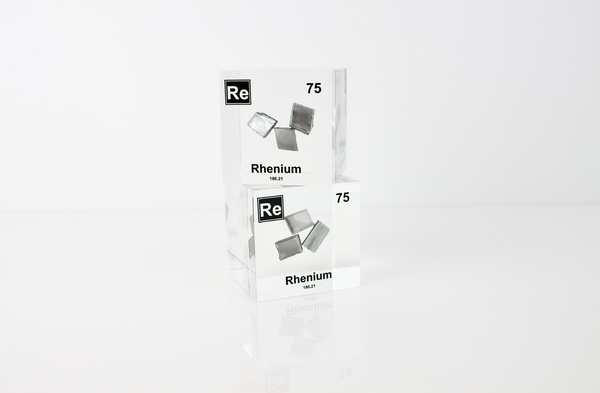 Rhenium element in a clear acrylic cube, featuring its name, atomic number, and properties as shown on the periodic table. A sleek and educational display for collectors and enthusiasts.