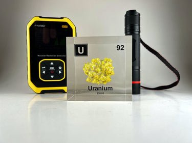 Clear acrylic cube showcasing a Uranium element (Atomic Number 92) embedded within, offering a scientific display for collectors and science enthusiasts.