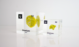 Clear acrylic cube showcasing a Uranium element (Atomic Number 92) embedded within, offering a scientific display for collectors and science enthusiasts.