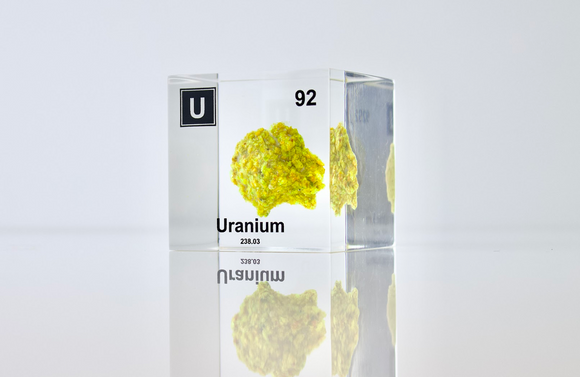 Clear acrylic cube displaying a Uranium element (Atomic Number 92) embedded within, offering a scientific presentation for collectors and science enthusiasts.