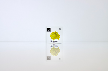 Clear acrylic cube displaying a Uranium element (Atomic Number 92) embedded within, offering a scientific presentation for collectors and science enthusiasts.