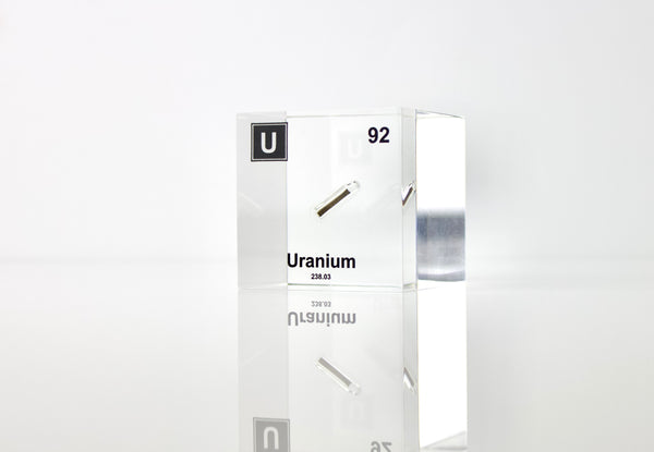 Clear acrylic cube displaying a Uranium element (Atomic Number 92) embedded within, offering a scientific presentation for collectors and science enthusiasts.