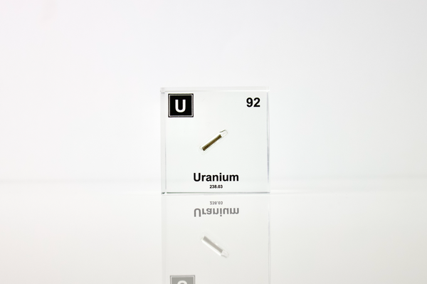 Clear acrylic cube displaying a Uranium element (Atomic Number 92) embedded within, offering a scientific presentation for collectors and science enthusiasts.