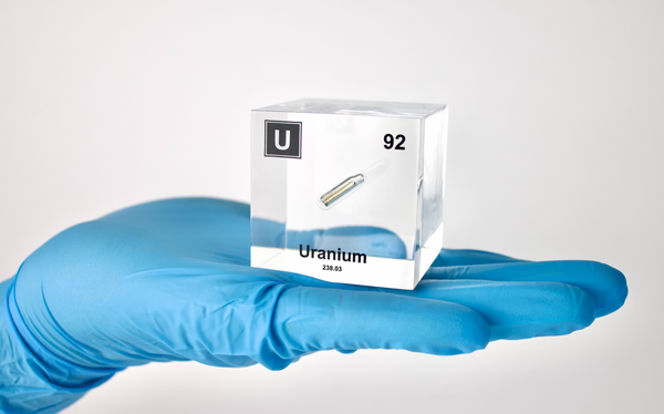 Clear acrylic cube displaying a Uranium element (Atomic Number 92) embedded within, offering a scientific presentation for collectors and science enthusiasts.