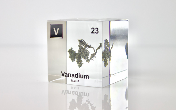 Clear acrylic cube displaying a Vanadium element (Atomic Number 23) embedded within, offering a scientific presentation for collectors and science enthusiasts.