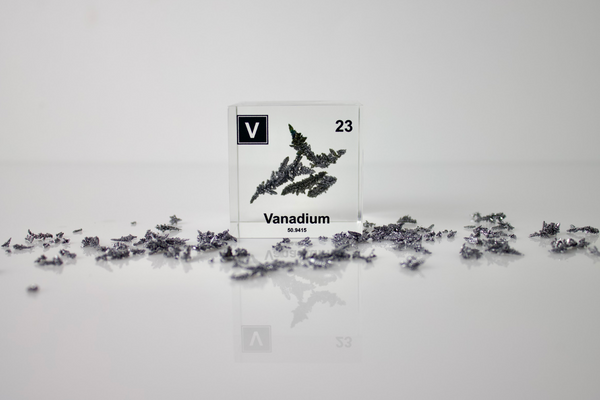 Clear acrylic cube displaying a Vanadium element (Atomic Number 23) embedded within, offering a scientific presentation for collectors and science enthusiasts.