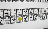 Close up of wall mounted periodic table of elements showing the elements cerium, praseodymium, neodymium, promethium, samarium, europium, gadolinium, terbium, thorium, protactinium, uranium, neptunium, plutonium, americium, curium, berkelium
