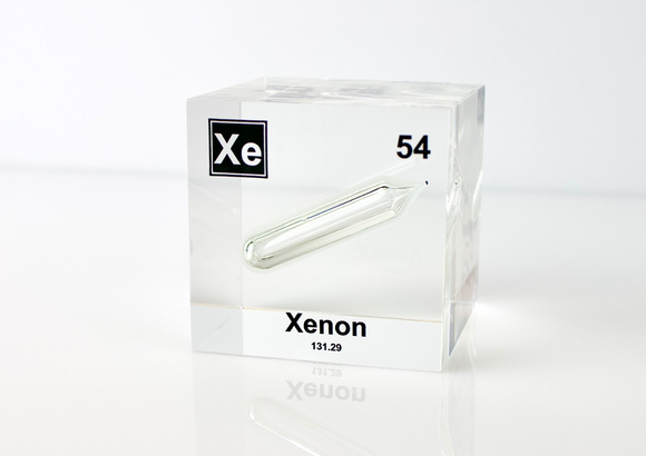 Clear acrylic cube displaying a Xenon element (Atomic Number 54) embedded within, offering a scientific presentation for collectors and science enthusiasts.