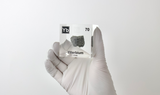 Clear acrylic cube displaying an Ytterbium element (Atomic Number 70) embedded within, offering a scientific presentation for collectors and science enthusiasts.