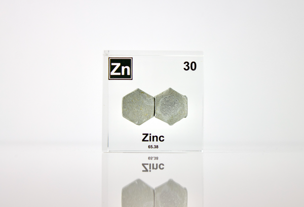 Zinc element encased in a clear acrylic cube, featuring its name, atomic number 30, and properties as displayed on the periodic table. Ideal for educational and collector use.