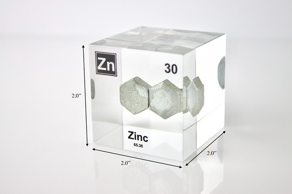 Zinc element encased in a clear acrylic cube, featuring its name, atomic number 30, and properties as displayed on the periodic table. Specifically showing its dimensions Ideal for educational and collector use. 