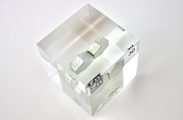 Zinc element encased in a clear acrylic cube, featuring its name, atomic number 30, and properties as displayed on the periodic table. Ideal for educational and collector use.