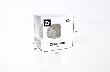 Clear acrylic cube displaying a Zirconium element (Atomic Number 40) embedded within, offering a scientific presentation for collectors and science enthusiasts.