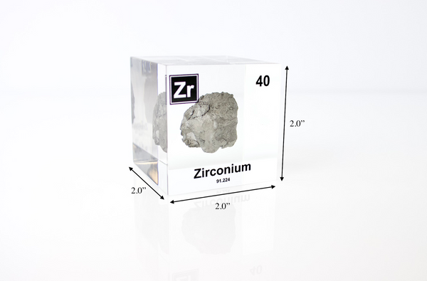 Clear acrylic cube displaying a Zirconium element (Atomic Number 40) embedded within, offering a scientific presentation for collectors and science enthusiasts.