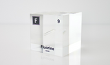 Clear acrylic cube encasing a Fluorine ampule with its atomic number 9. Ideal for display in educational settings, scientific collections, or as a decorative piece.
