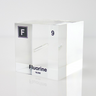 Clear acrylic cube encasing a Fluorine ampule with its atomic number 9. Ideal for display in educational settings, scientific collections, or as a decorative piece.