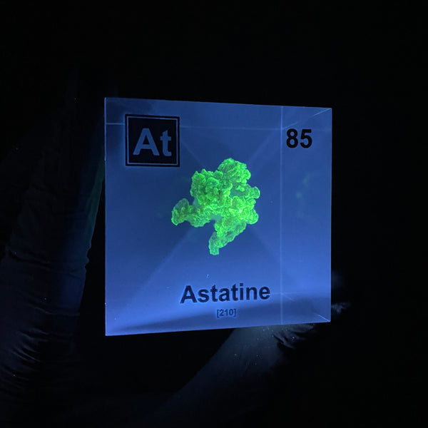 Clear acrylic cube displaying an Astatine element (Atomic Number 85) embedded within, offering a scientific presentation for collectors and science enthusiasts.