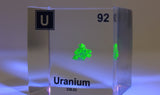 Clear acrylic cube displaying a Uranium element (Atomic Number 92) embedded within, offering a scientific presentation for collectors and science enthusiasts.