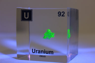 Clear acrylic cube displaying a Uranium element (Atomic Number 92) embedded within, offering a scientific presentation for collectors and science enthusiasts.